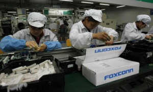 Operai al lavoro in Cina in una catena di montaggio della Foxconn